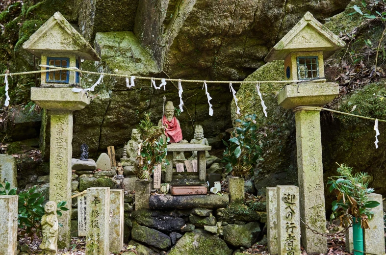 an oriental garden set on display in front of a rock wall