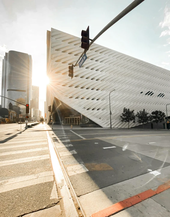 a traffic light is on in front of a triangular building