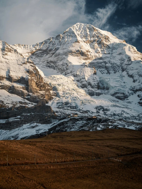 a snowy mountain is pictured at sunrise in this pograph