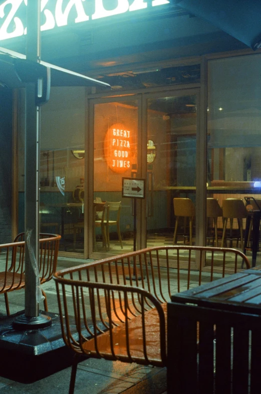 a lighted up sign sitting on the side of a building