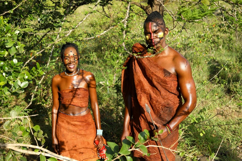 a man and woman with their orange robes covered in mud