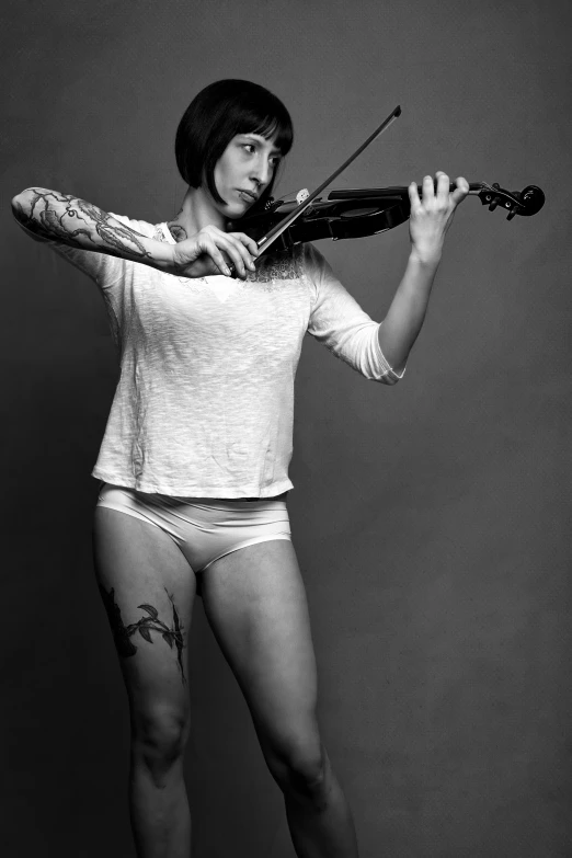 a woman in a  that is playing a violin