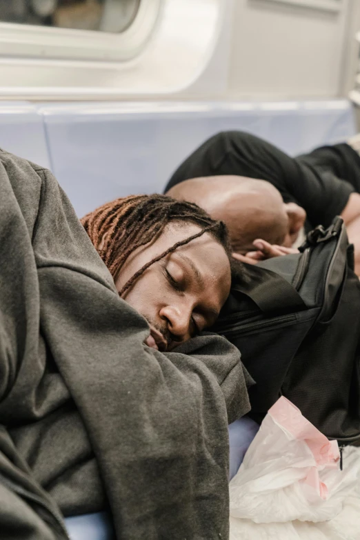 an african american woman sleeping on a commuter train