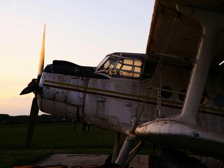 the front of an old plane sitting on the ground