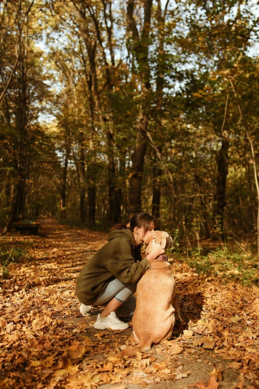 the man is petting his dog on his knee