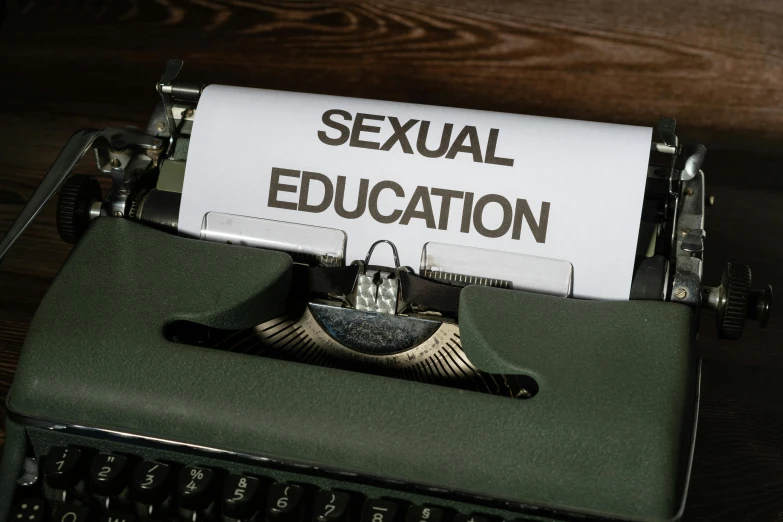 a paper on top of a typewriter that reads sexual education