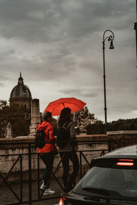 two young people walking through the city on an overcast day