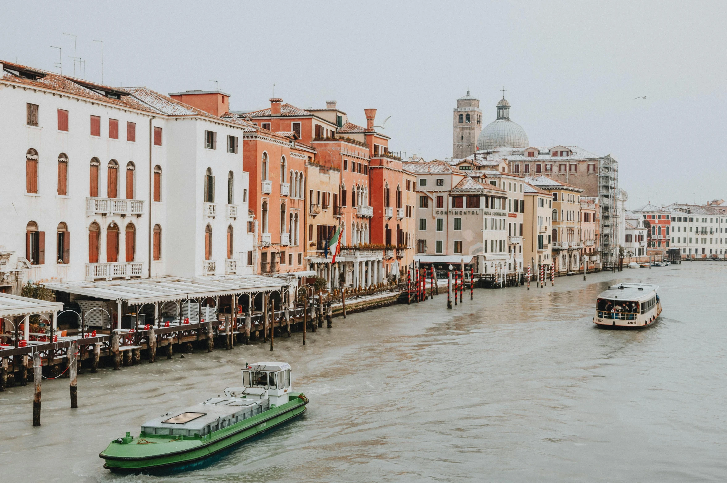 boats on the water at a river with buildings