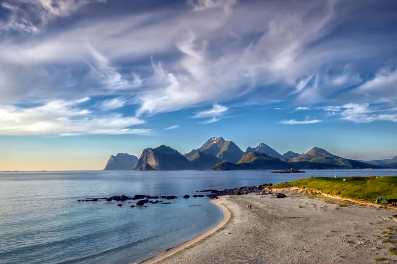 an image of some mountains and water at day