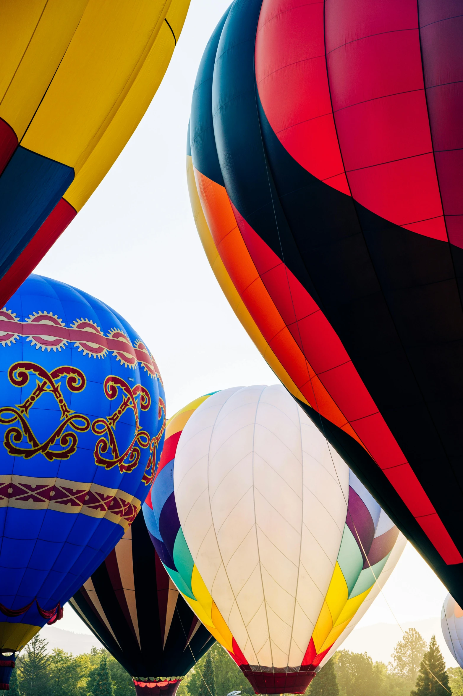 a bunch of large balloons floating in the sky