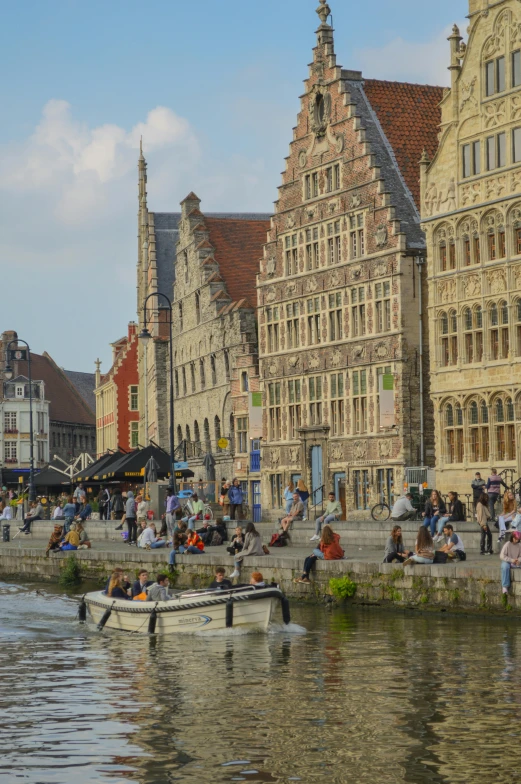 a group of people are floating in the water next to old buildings