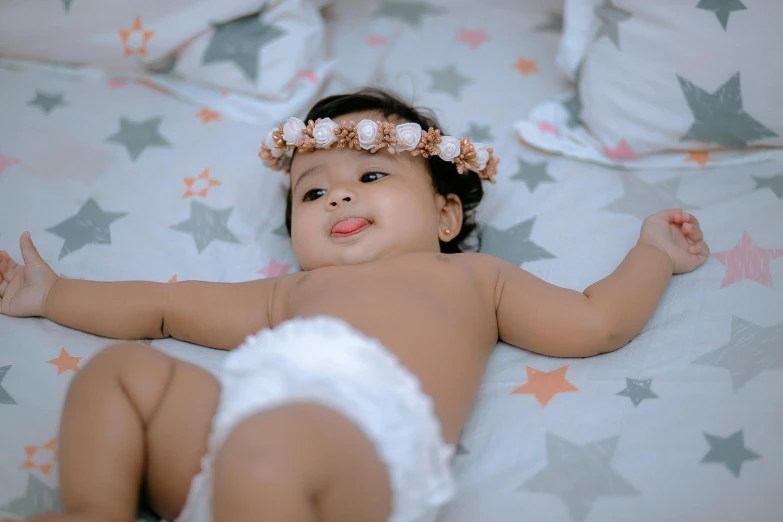 baby with two bows on top of her head in diaper