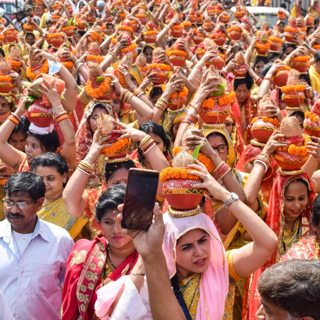 a crowd of people taking pictures with their cell phones