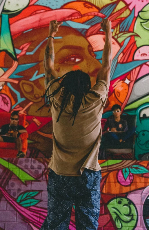 there is a man on the skate board skating in front of a wall