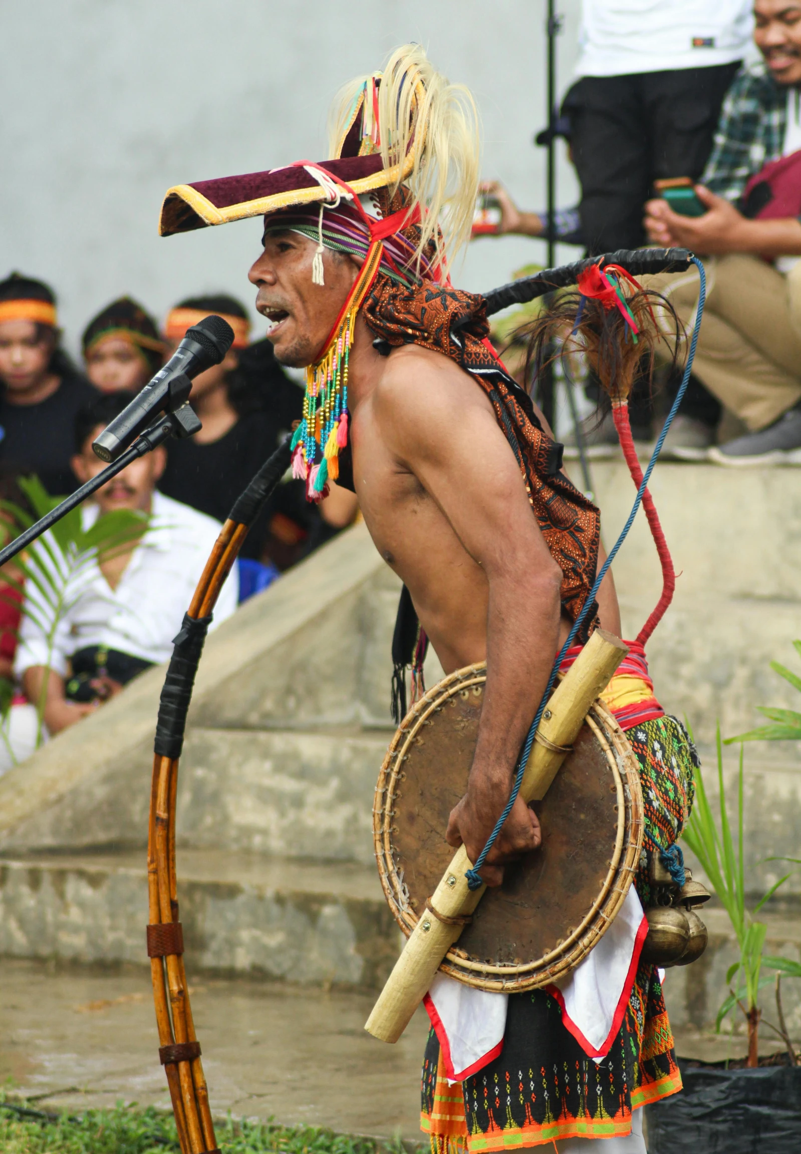 an indian man in traditional clothing, holding a large sword