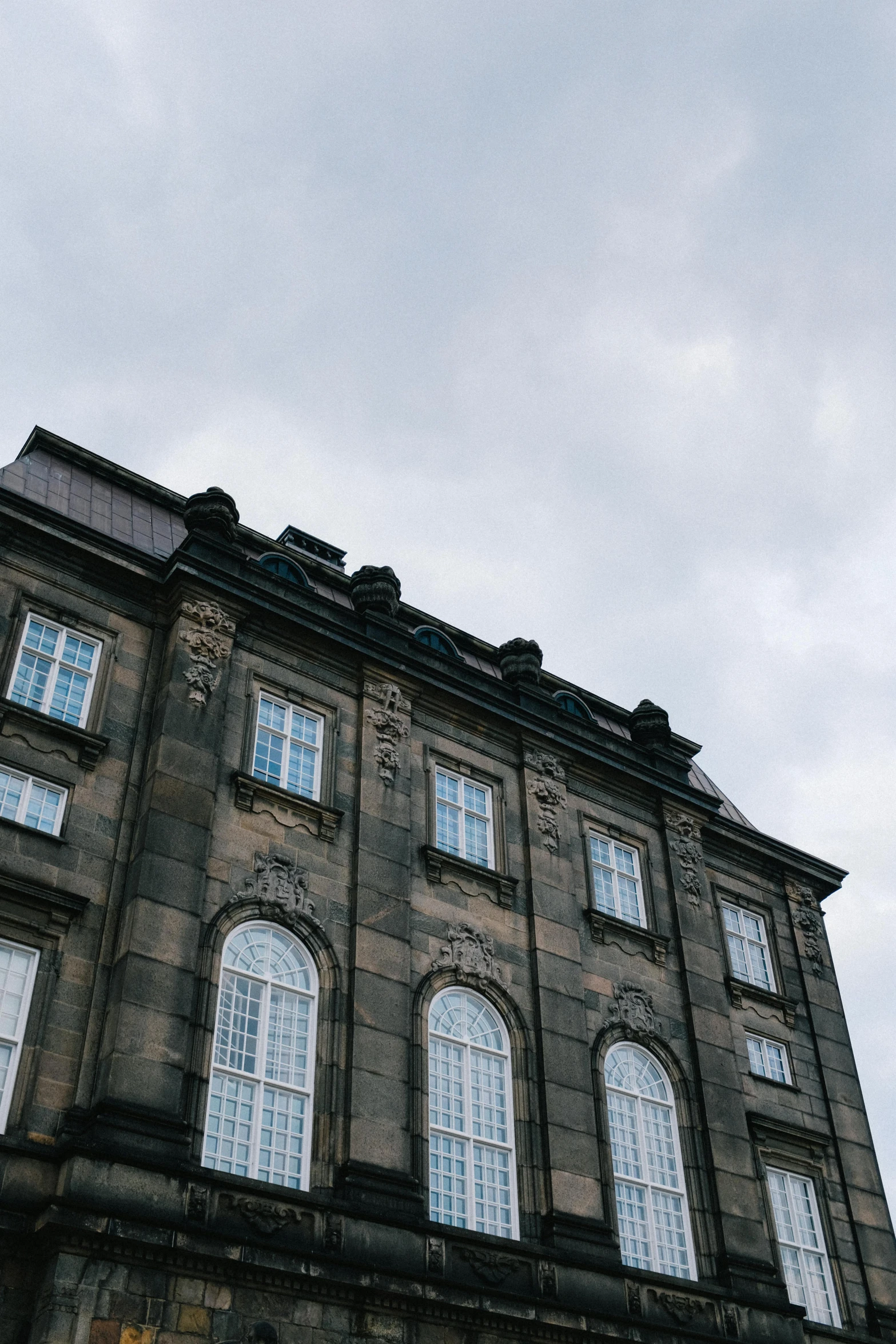 an old building with lots of windows and a clock on the front