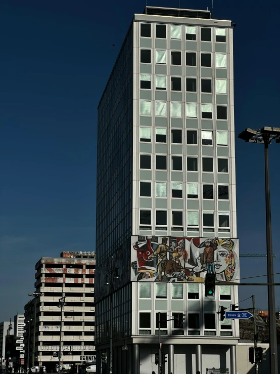 a tall building with windows is against a blue sky