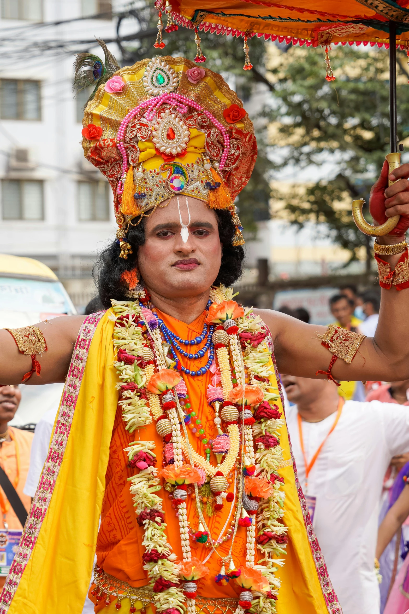 the man in the costume is holding an umbrella