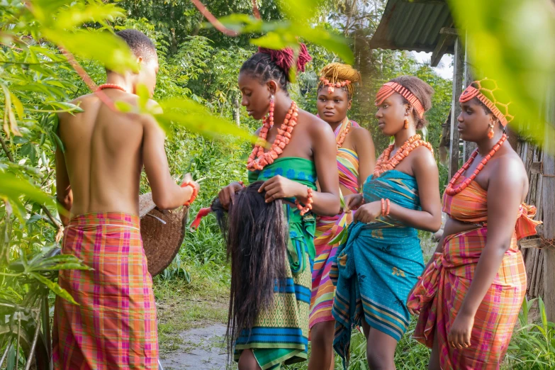 a group of young people standing in front of trees