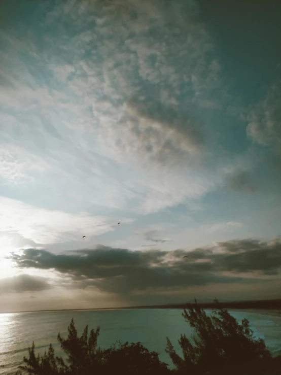 clouds in the sky above a body of water