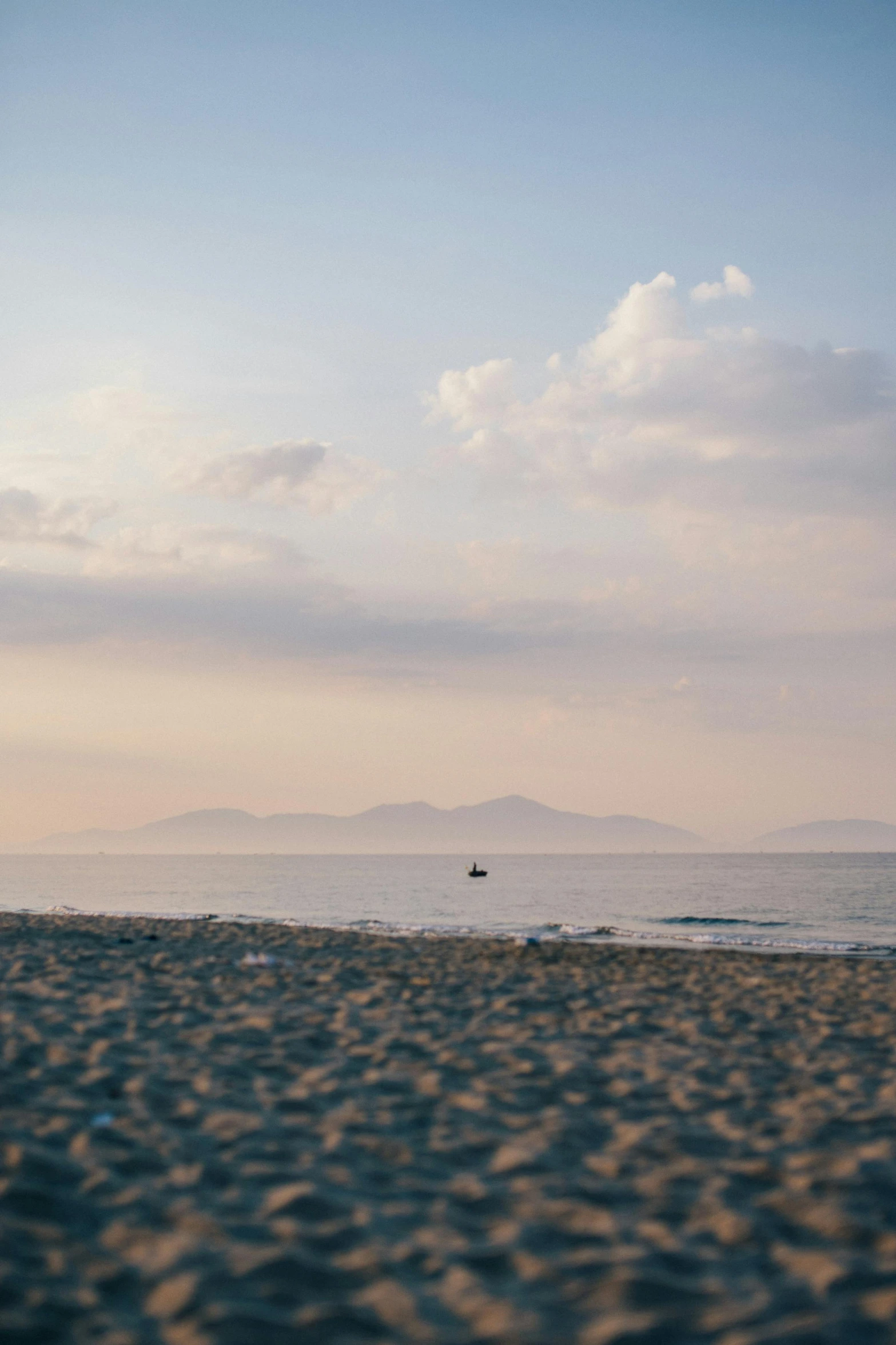 a person on a beach walking near the water