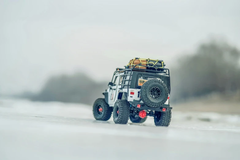 a truck traveling down the road in the snow