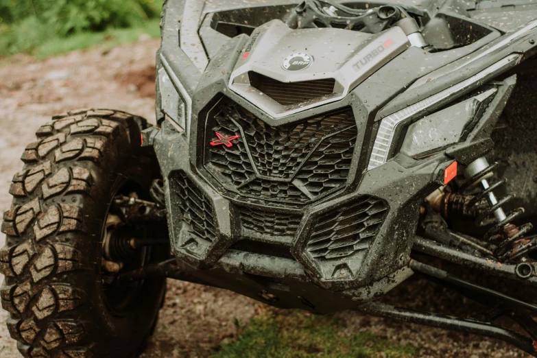 this is the front end of a vehicle parked in some mud