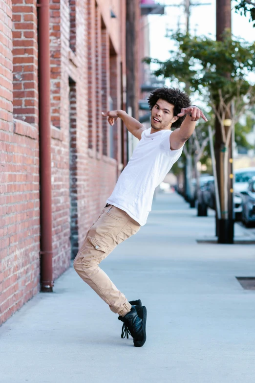 a man in white shirt jumping on a skateboard