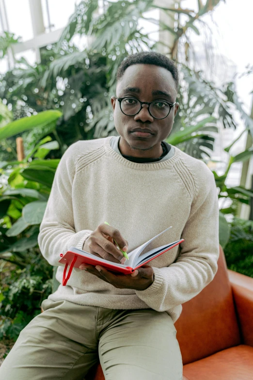 an african american man sits on a bench in the garden house