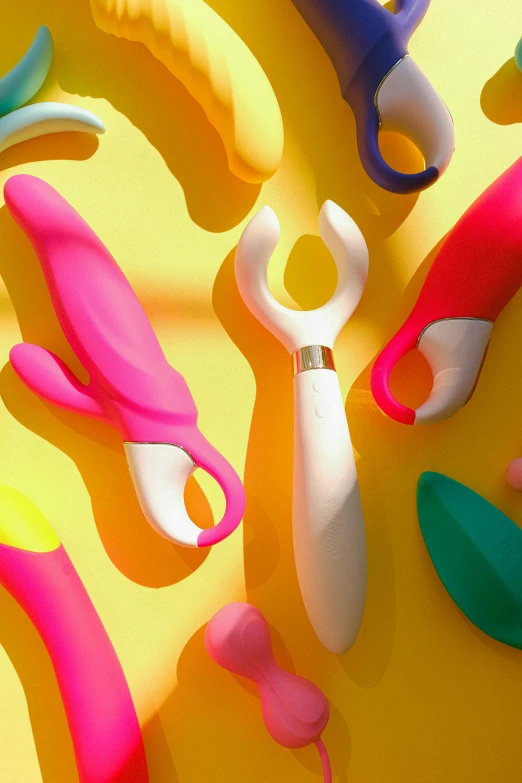 a variety of plastic objects on yellow background