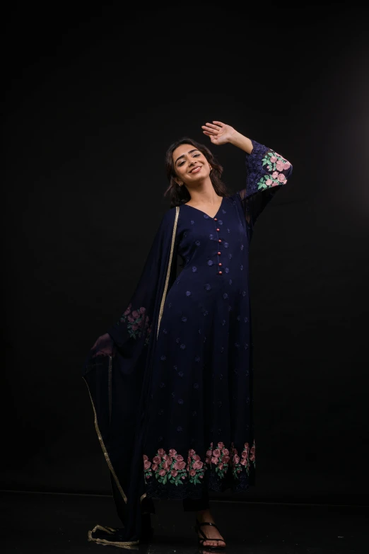 a woman wearing an ethnic blue dress with a flowered print