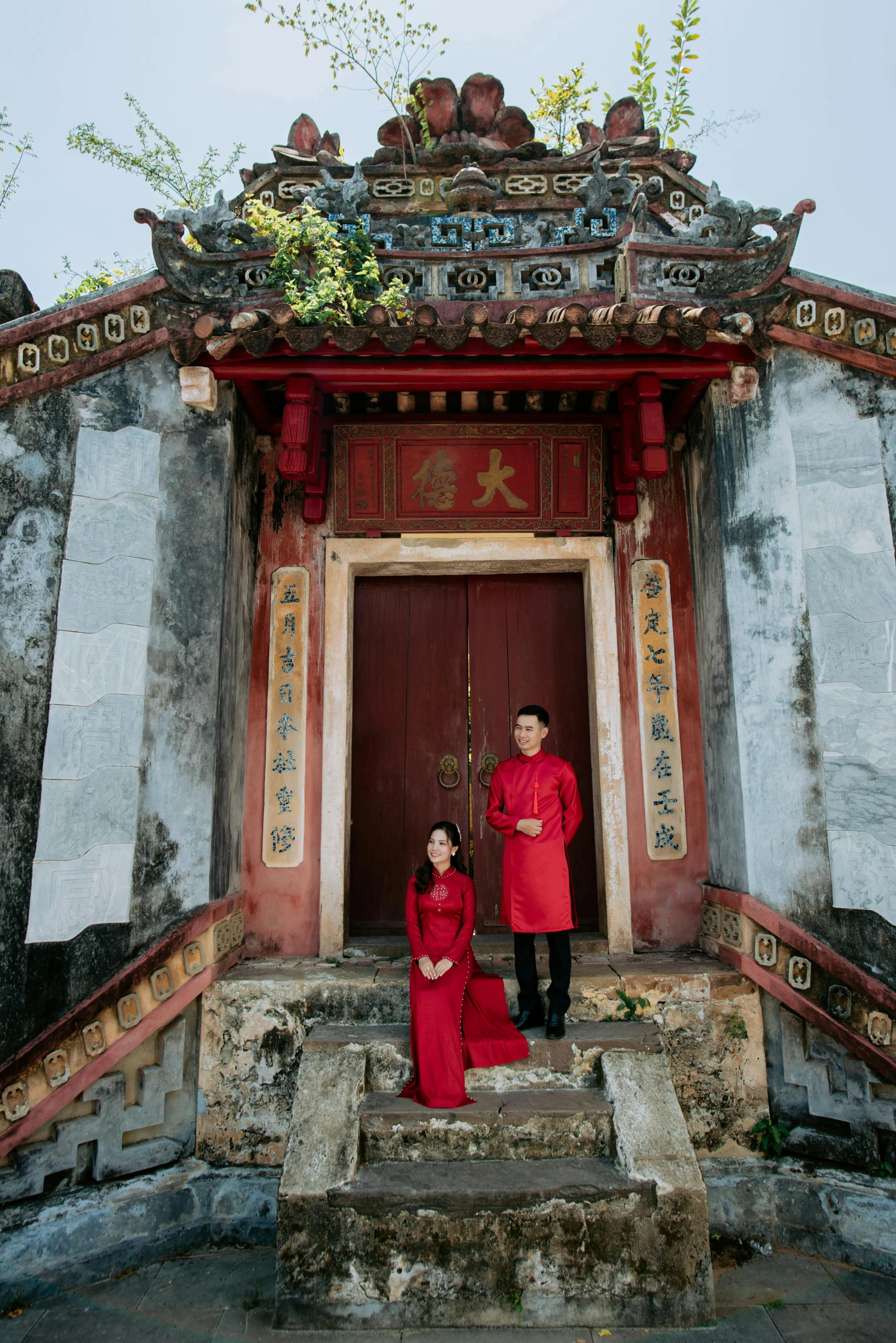 a man and woman standing on steps in front of a doorway