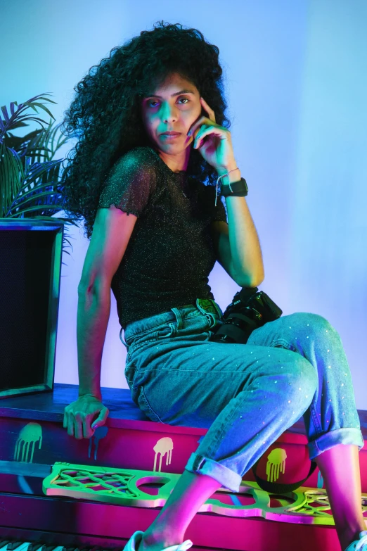 a girl with a handbag sitting on the edge of a bench