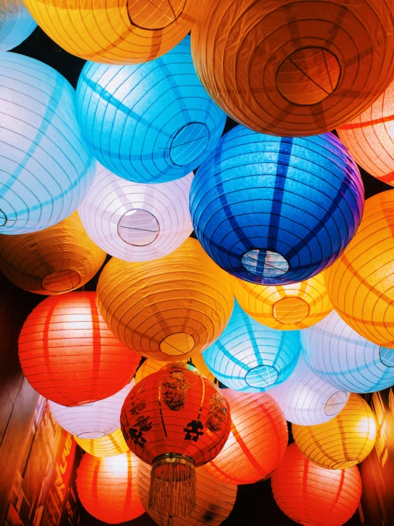 many colored lanterns hang overhead at the same time