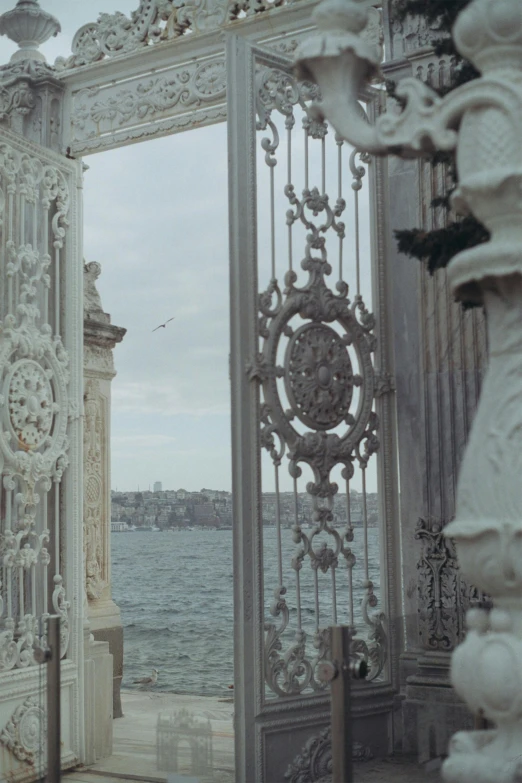 a couple of white gates leading out into the ocean