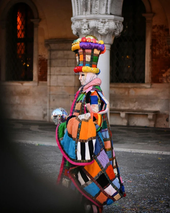 a colorful sculpture sitting on top of a sidewalk