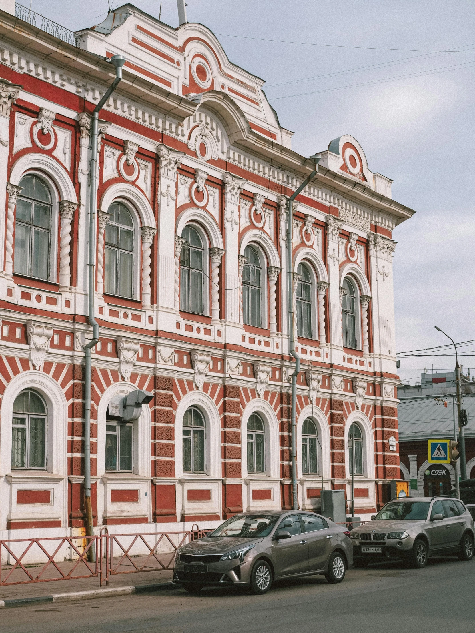 an old red building with a lot of cars parked on the side of it