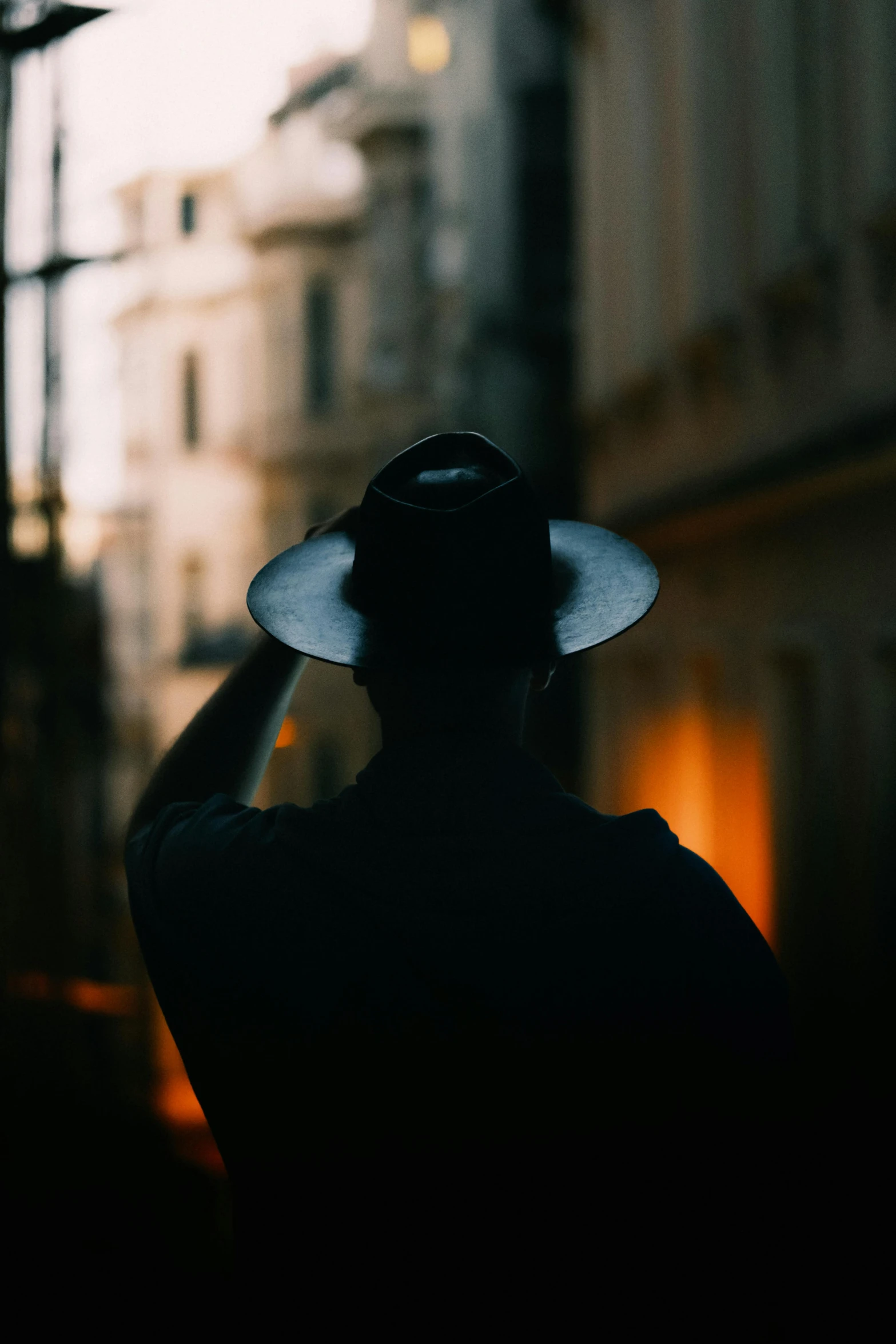 a man with a hat on in the middle of the night