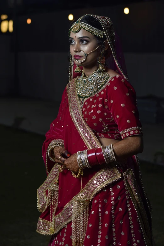 the bride in a red bridal outfit at her wedding