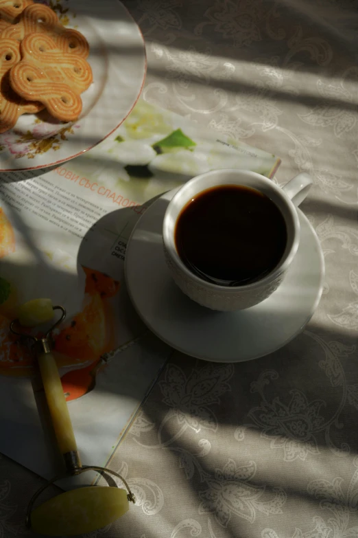 the tea cup has been placed next to cookies