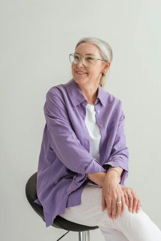 an older lady sitting on top of a black chair