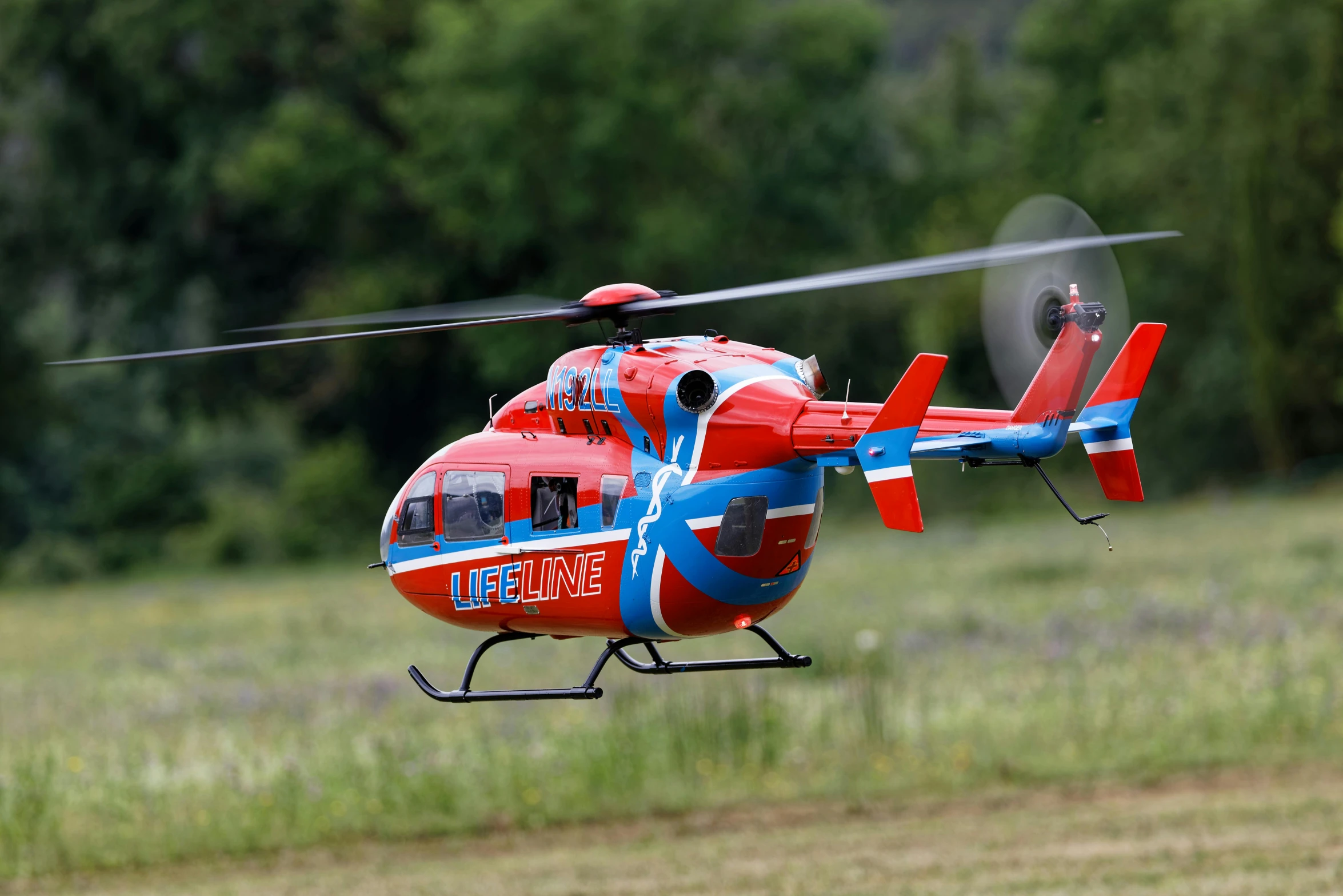 an image of a red helicopter in the air