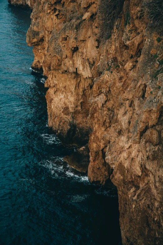 an aerial view of a rocky beach near the ocean