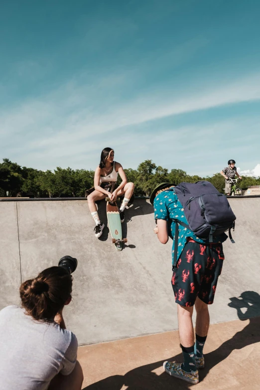 a woman looking up at another person doing a skateboard trick