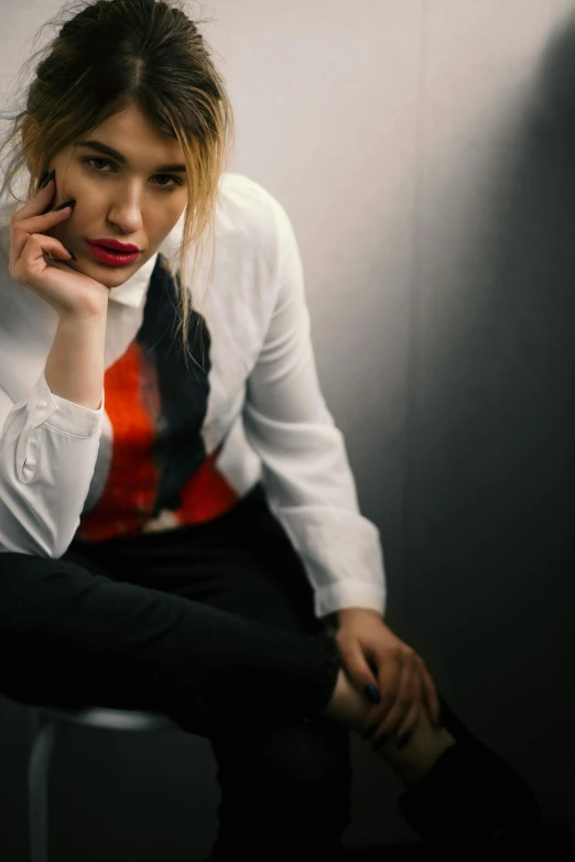 a woman with a tie and jacket on posing for the camera