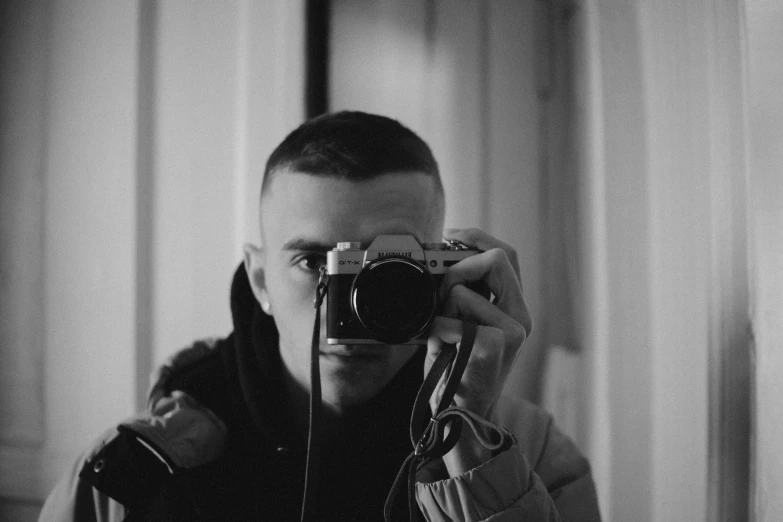 a black and white po of a man holding a camera
