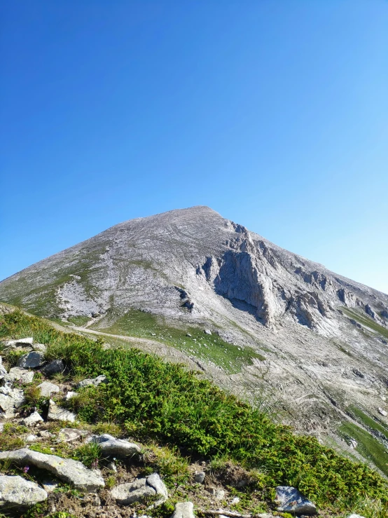 the view of the summit of the mountain has many plants and rocks