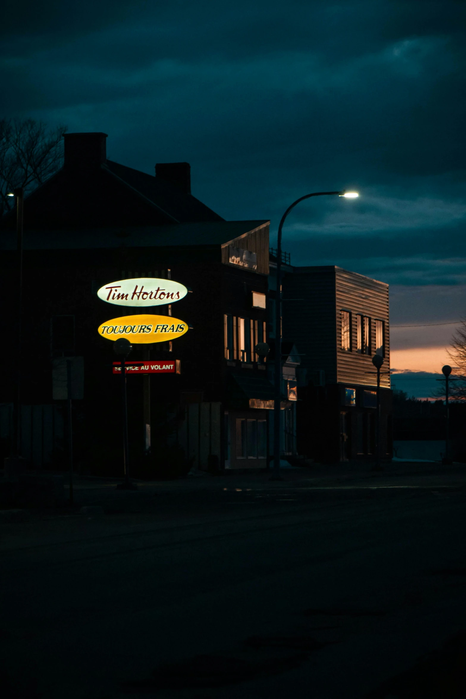 a sign for the restaurant is lit up at night