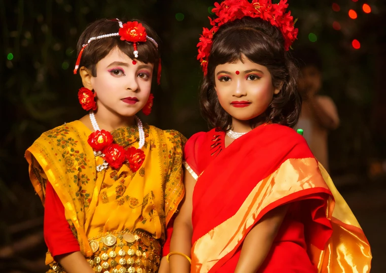 two girls dressed in elaborately decorated costumes