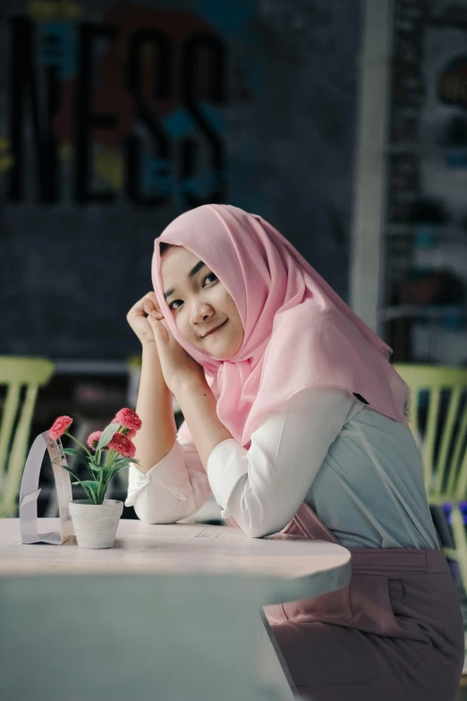 a woman is smiling as she leans over a table